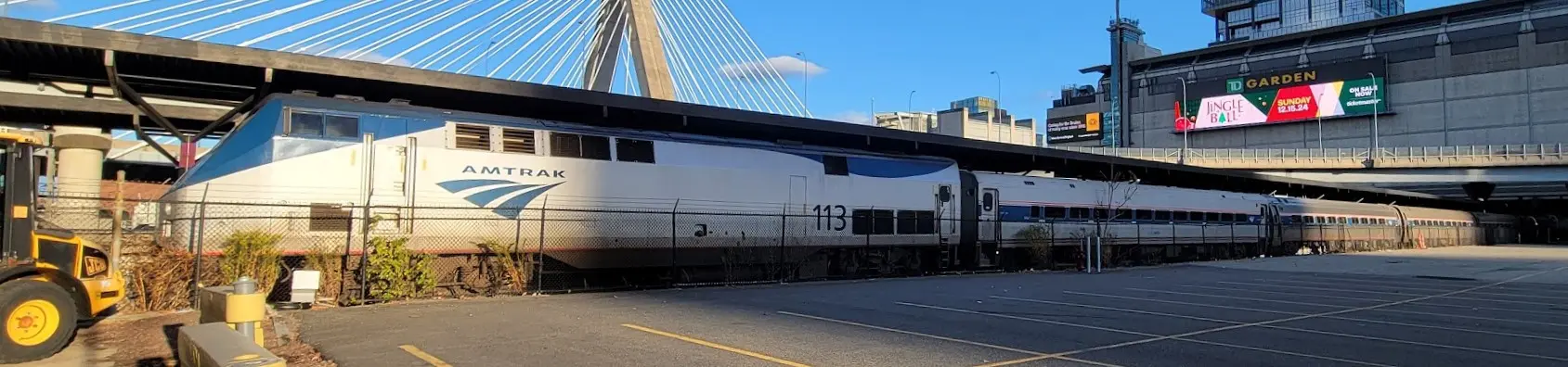 Amtrak Downeaster train behind a fence