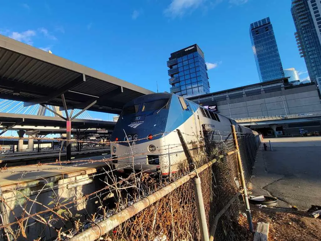 Amtrak Downeaster train behind a fence